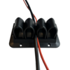 Four arch-shaped holes, fixed on a black plastic frame, with blue and white cables running through them and screw holes around the edges.  